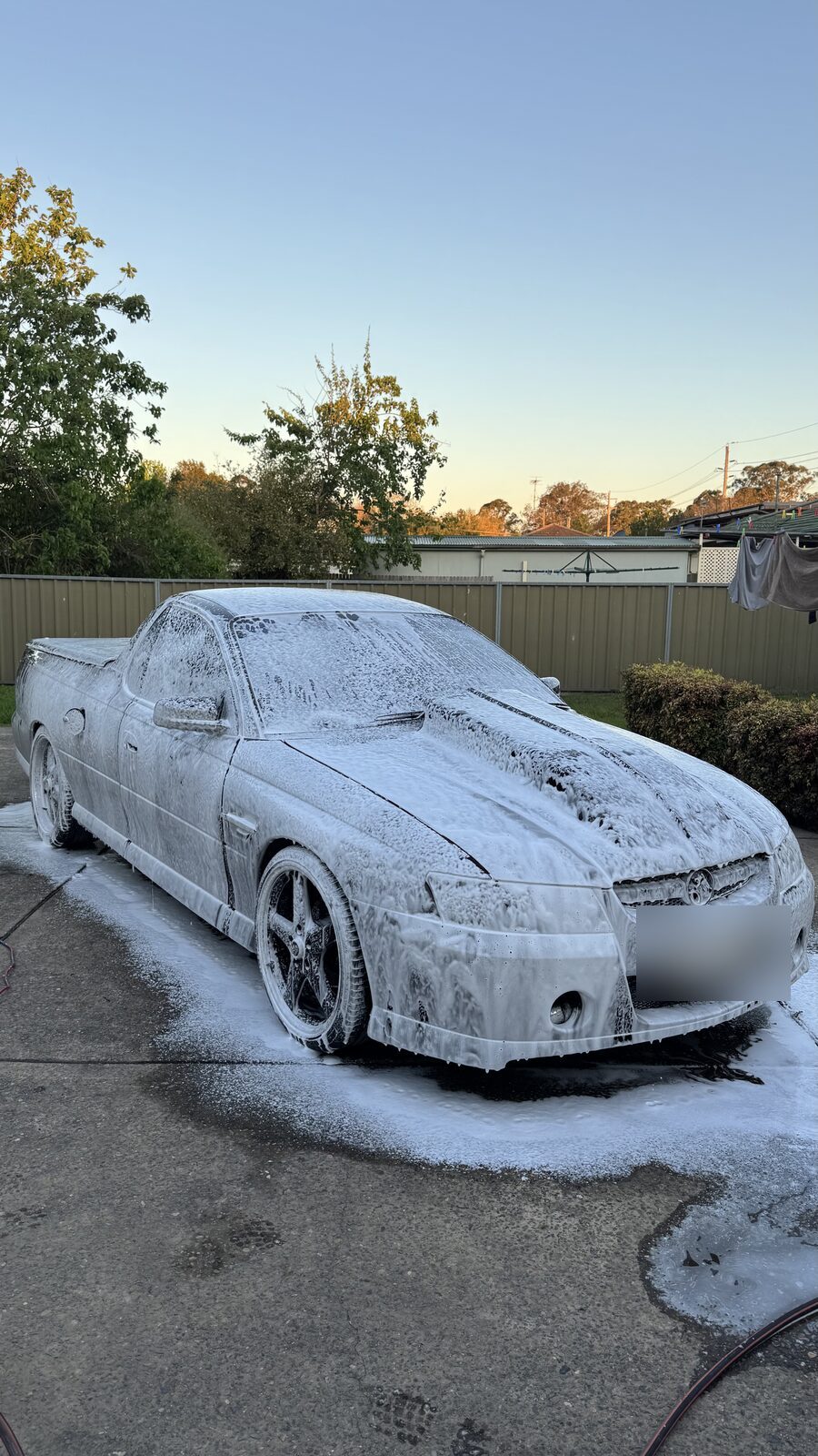HSV Maloo ute covered in thick snow foam during the pre-wash